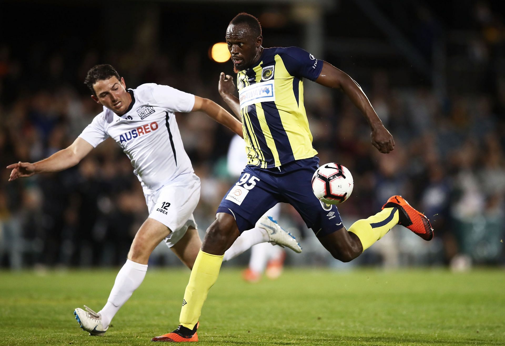 Usain Bolt of the Mariners beats Josh Symons of Macarthur South West United during the pre-season friendly match at Campbelltown Sports Stadium on October 12, 2018 - Source: Getty
